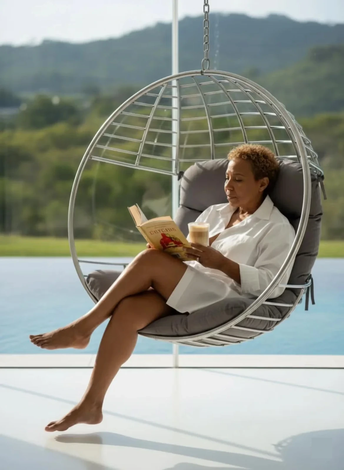 Sharon Terry reading poolside in a hanging chair — reflecting on personal growth and self-discovery